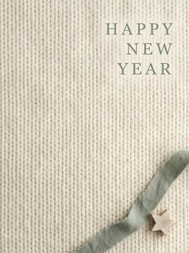 Happy new year greeting card design with soft cream knitted texture background and decorative ribbon