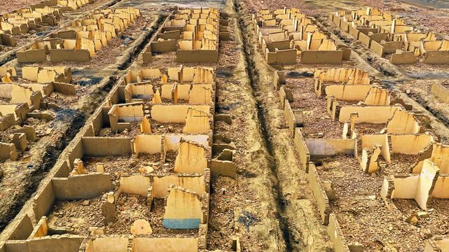 Elevated view of abandoned mud brick building ruins at Lenghu Oil Base Site in Mangya City, Qinghai Province, China.