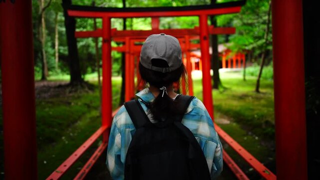 Woman Walking Through Torii Gates at Kashihara Jingu Shrine Japan