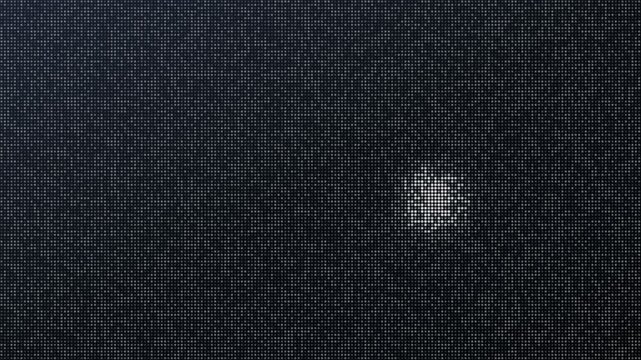 Abstract silver sequin background with a moving light reflection shimmering across the textured surface