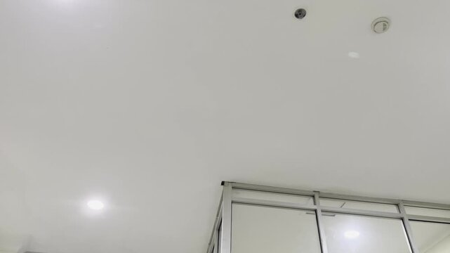 White Ceiling Plasterboard Sheet With Recessed Downlight Lamp Close Up