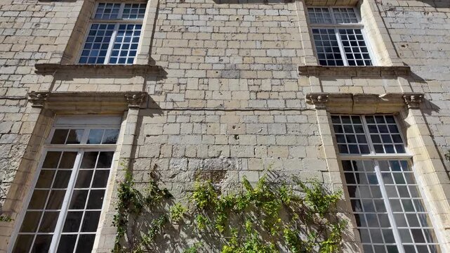 Tall white framed windows and carved stone lintels decorate the pale limestone facade of Ch&acirc;teau d'Uss&eacute; in the Loire Valley, France