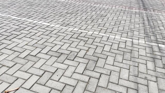 Paving block street texture with herringbone pattern background