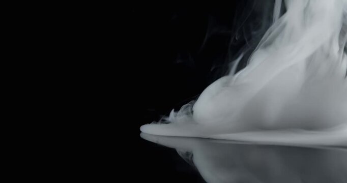 Real eerie smoke swirling like a hurricane or tornado. Vortex of wispy smoke spinning creating a mystical ghostly aura of the paranormal or a spooky Halloween background visual effect or overlay.