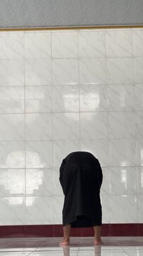 Man Standing in Prayer in a Mosque