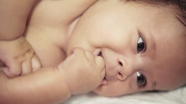 16 Week Old Boy Chewing Fingers close up