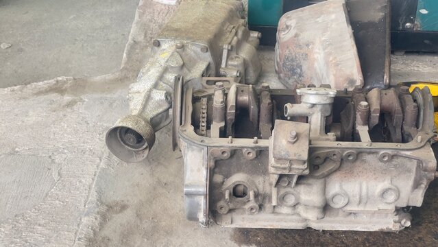 Broken engine cylinder head showing heavy wear and carbon deposits