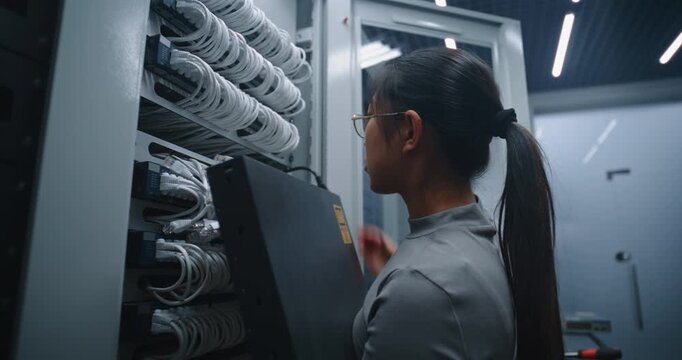 Server Room Technician Installs Replacement Network Hardware In Server Rack Using Hand Tools. Modern IT Maintenance, Equipment Servicing, Infrastructure Modernization and Reliable Connectivity.