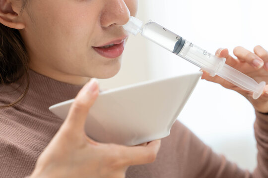 Close-up shot of woman cleaning her nasal.