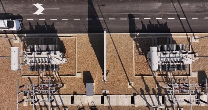 Serbia - 15 April 2026: Aerial view of power substation transformers with gravel ground and road.