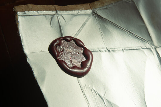 Red Wax Seal Stamp Pressed on Foil Paper Surface of Milk Carton Packaging for Decorative Design