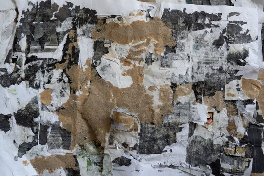 Grunge Texture of Peeled Brown Black and White Advertising Poster Paper Left on Urban Street Wall