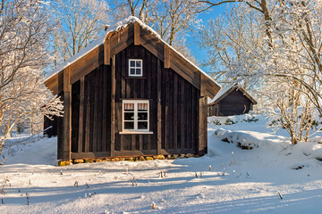Wooden croft house surrounded by fresh snow in a winter landscape © Lars Johansson