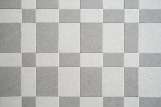 Grey and white square floor tiles in a regular checker