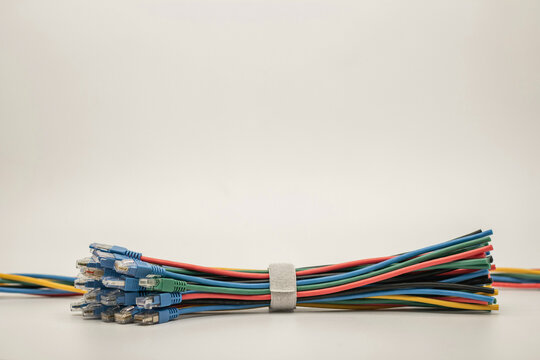 Coloured network patch cables gathered in a velcro tie