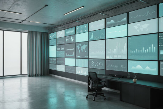 A wall of dashboard screens glowing in an empty control room