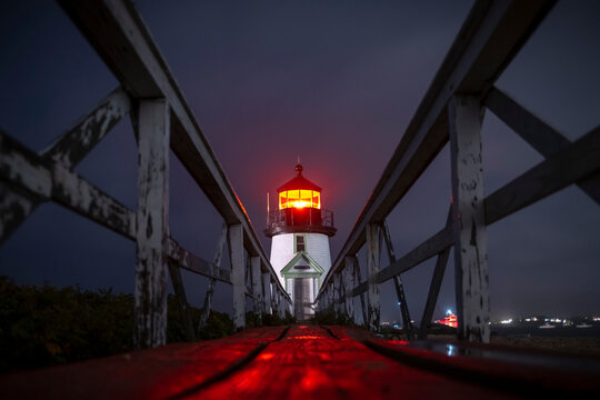 Wooden walk at the Brant Point Lighthouse at night in Nantucket.