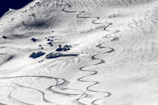 Winding ski tracks on a snow covered mountain