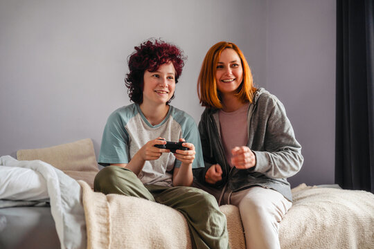 Mother and teenage girl enjoying digital entertainment together