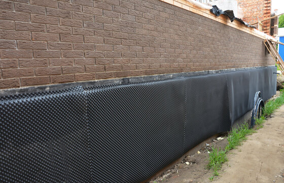 Waterpoofing house foundation wall with waterproof membrane