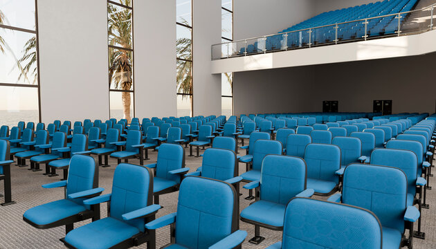 Empty auditorium with blue chairs and large windows showing palm trees