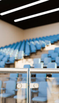 Indoor stadium seating with blue chairs and glass railing