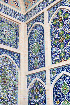 Ornate tilework at Ulugh Beg Observatory in Samarkand featuring intricate floral and geometric patterns in blue and green. Ideal for travel publications, cultural heritage materials, and design.