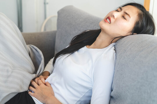 woman have a stomach pain from menstruation at home.
