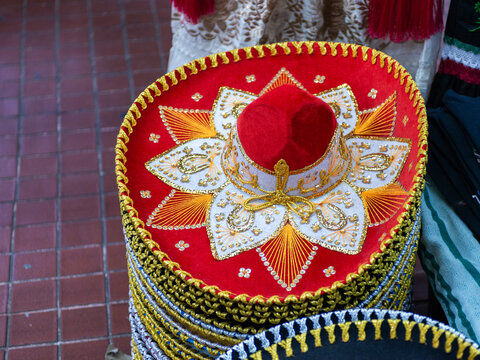 Red Mexican Charro Sombrero with Gold Embroidery at a Street Market
