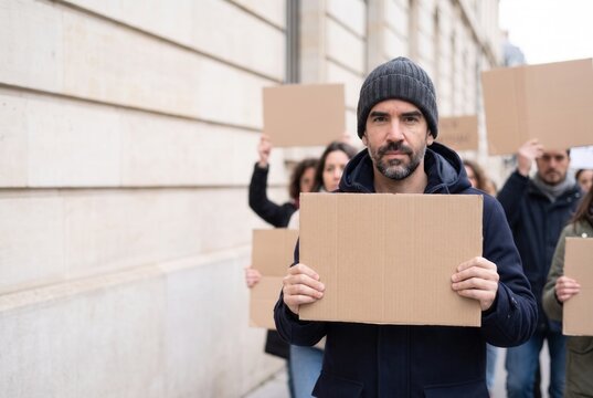 Man holding a blank placard at a peaceful demonstration