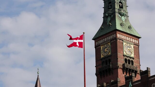 Historic Copenhagen City Hall and national flag of Denmark
