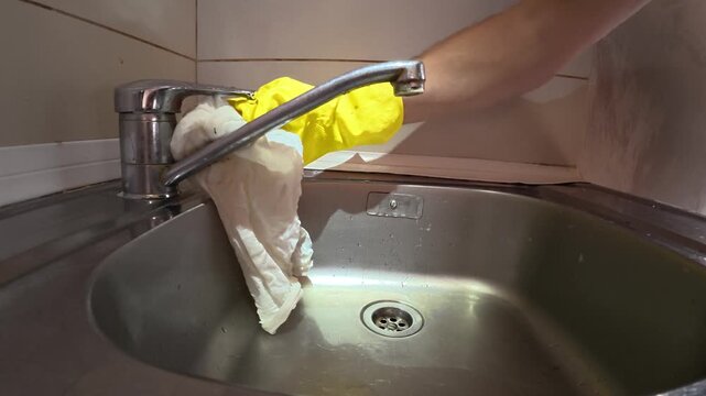 Polishing Clean Chrome Kitchen Faucet with White Cloth