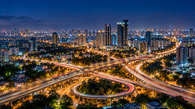 Aerial Bengaluru city lights and highway trails at night