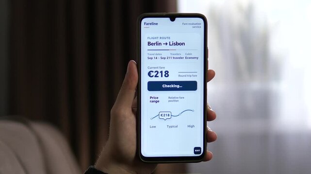 Traveler checks a Berlin to Lisbon flight fare on a smartphone, using a mobile price tool to compare ticket cost and market range before booking.
