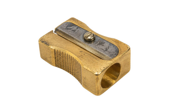 Old brass pencil sharpener with a metal blade and screw is isolated on a clean white background