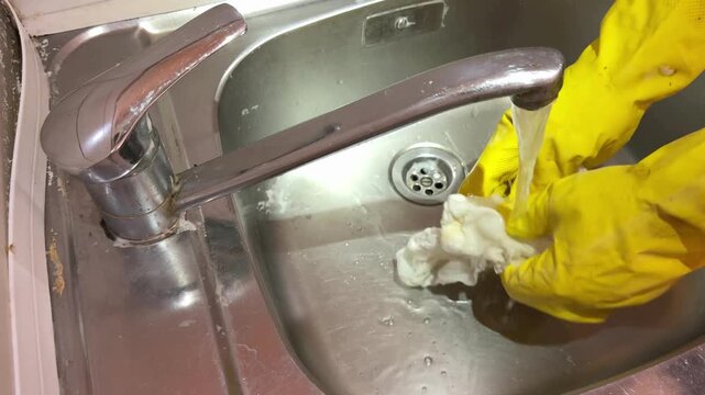 Rinsing and Wringing Cleaning Cloth Under Running Water