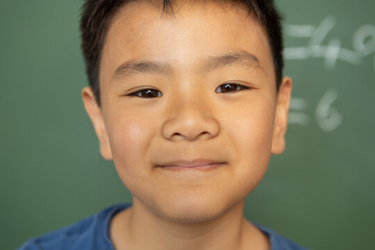 Schoolboy looking at camera in a classroom