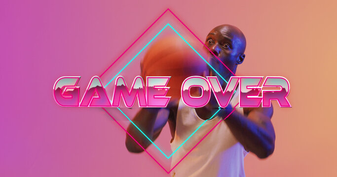 Image of game over text over neon pattern and african american basketball player
