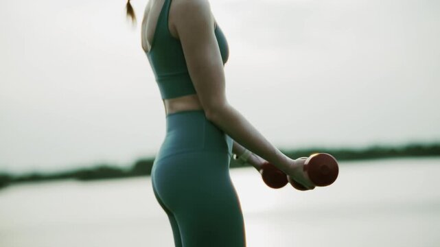 Athlete Performing Bicep Curls With Dumbbells During Outdoor Fitness