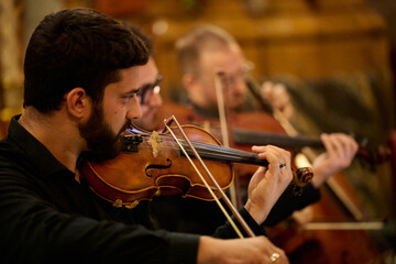 Musicians playing violins in beniarrés church concert © Cristian Blázquez