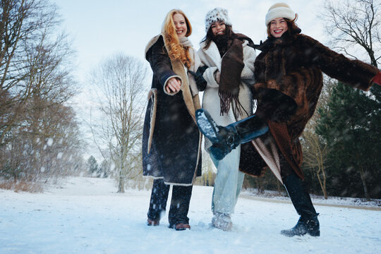 Friendship brings women together for snow play at the park
