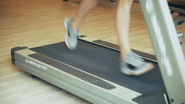 Runner Moving On Treadmill Belt During Indoor Cardio Training 
