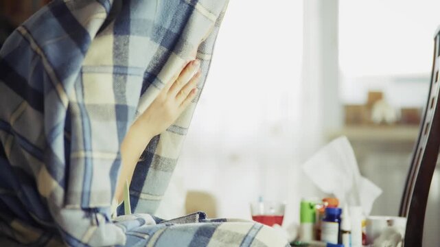 ick Person Wrapped In Blanket Sitting Near With Medicine And Tissues At Home