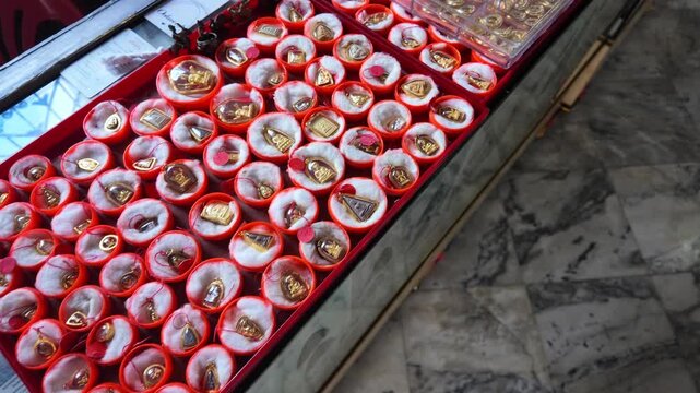Buddhist Amulets Displayed on Market Stall in Bangkok