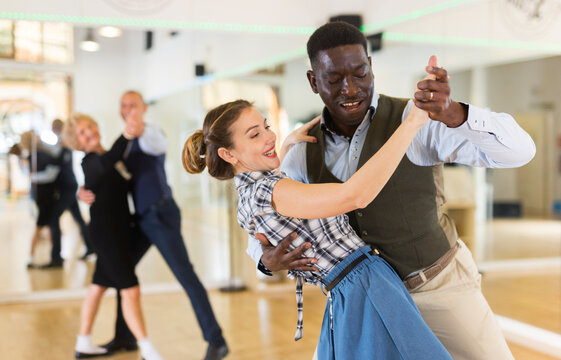 Woman with american man practising ballroom dancing