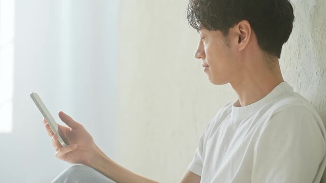 A man using a smartphone. Apps, social media, videos, email, digital transformation, games, relaxation, young people, search, smartphone