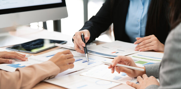 Close Up of Business Team Hands Analyzing Financial Report Documents at Office Desk