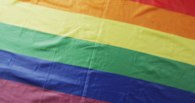 Image of rainbow flag lying on white background