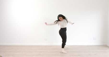 Dancing gracefully, woman expressing joy and movement in dance studio © WavebreakMediaMicro