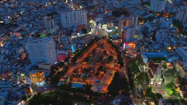 Panoramic aerial view over the bustling cityscape of Ho Chi Minh City, Vietnam showcasing busy streets, vibrant nightlife traffic, and dense urban sprawl at twilight.